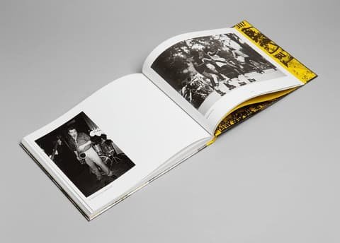 Open book Shot by Both Sides with two dark black and white photographs, seen from above