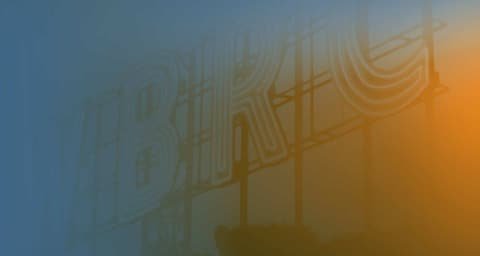 Premotion key visual: gradient from blue to orange with lettering shining through