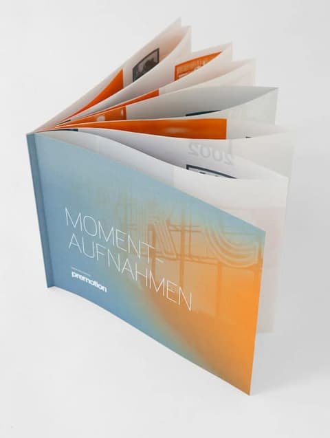 Premotion booklet standing upright with its pages fanned out
