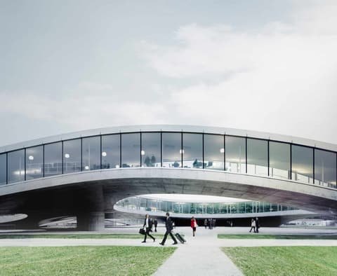 Photo production for Switzerland Global Enterprise: people walking beneath a low, curved modern building
