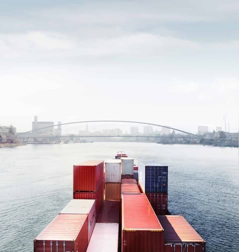 Photo production for Switzerland Global Enterprise: container ship on a misty river heading for a bridge