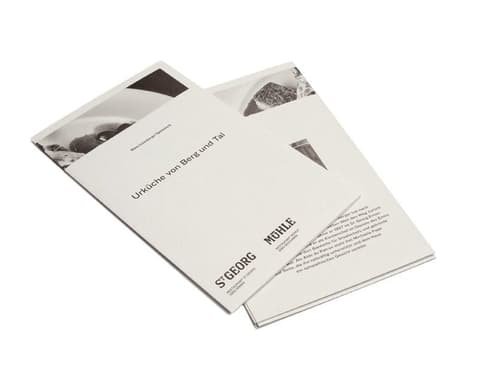 Two folded leaflets for the restaurants St. Georg and Mühle with black-and-white photos
