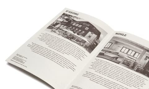 Open leaflet with text and black-and-white photos of the St. Georg and Mühle buildings